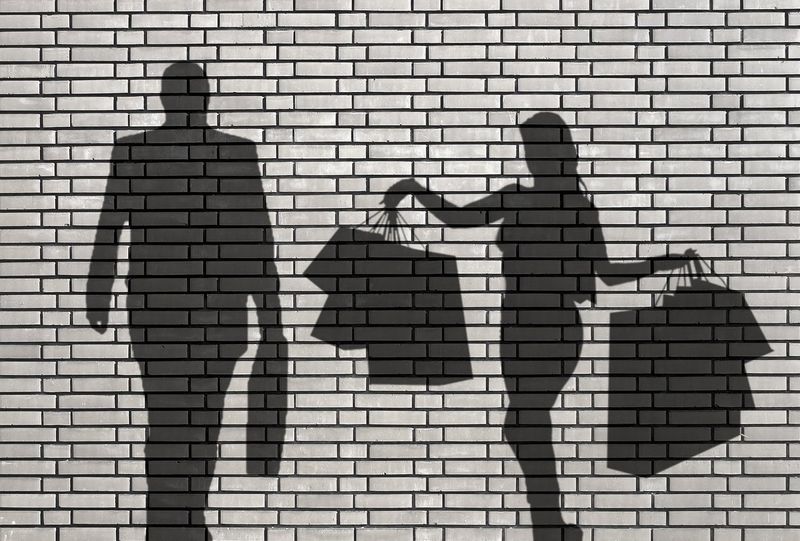 Silhouette of a cliche - woman with too much shopping and gifts