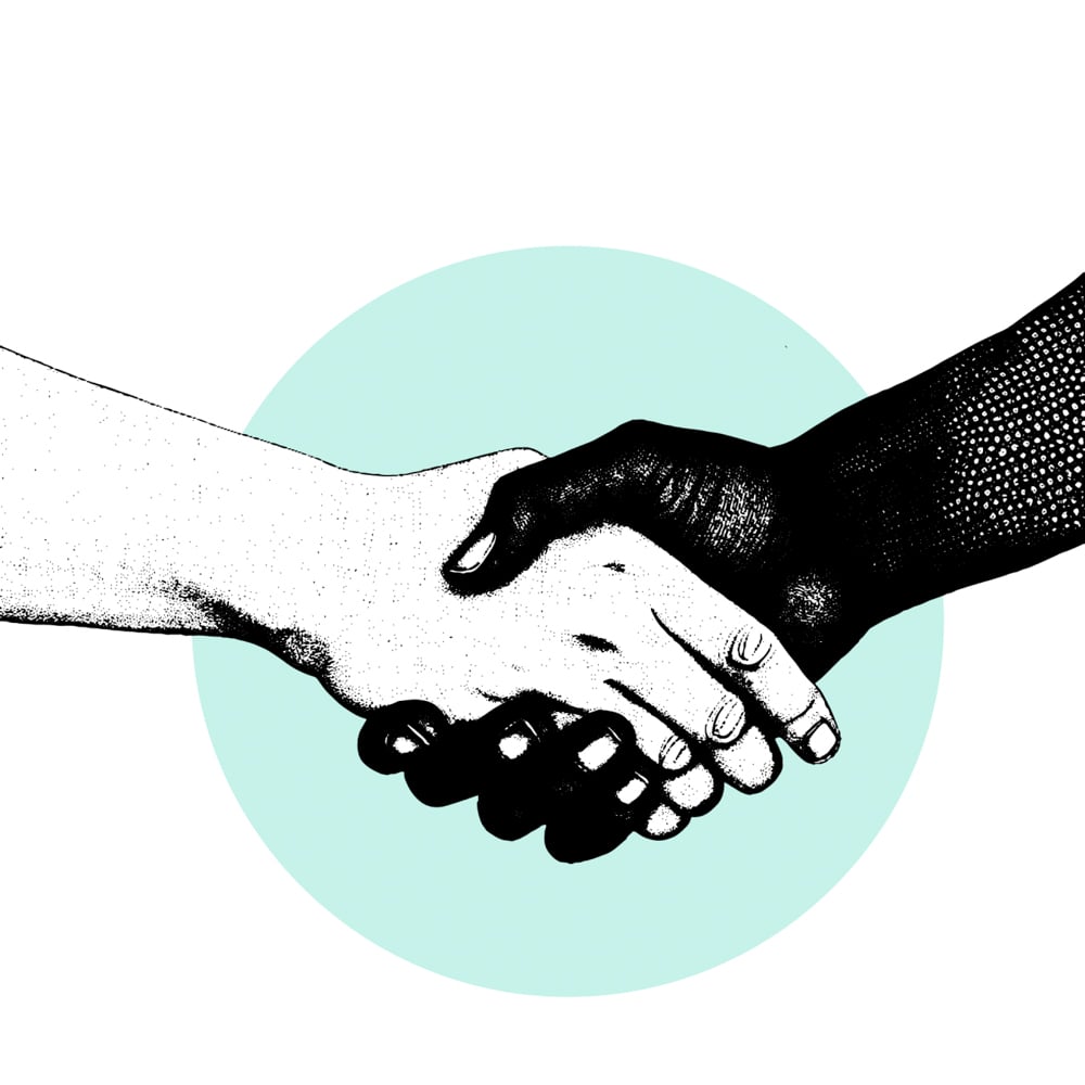 Two people handshaking each other