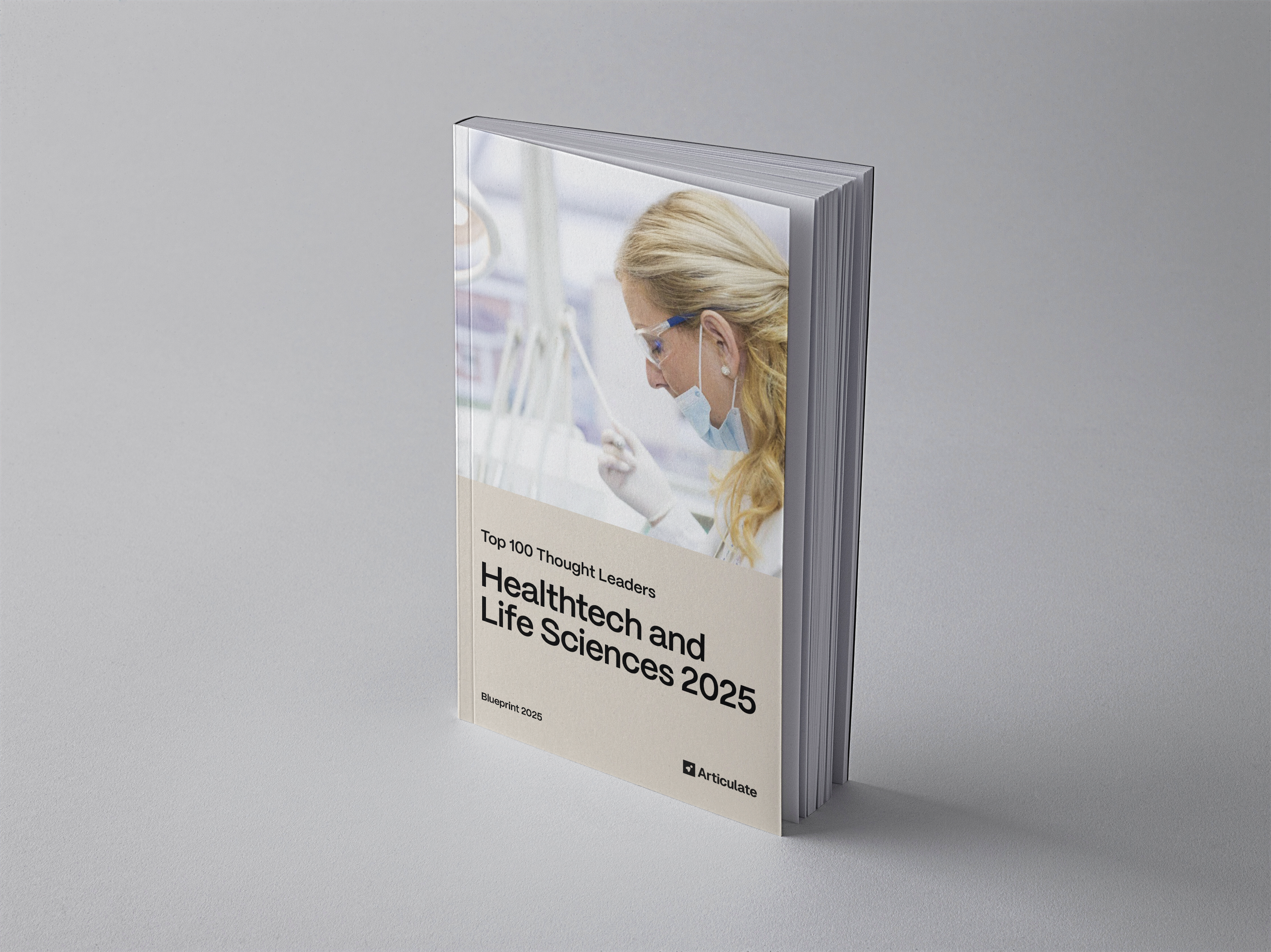 Image of a book showing a scientist in a lab with the title 'Blueprint - Top 100 Thought Leaders - Healthtech and Life Sciences 2025'