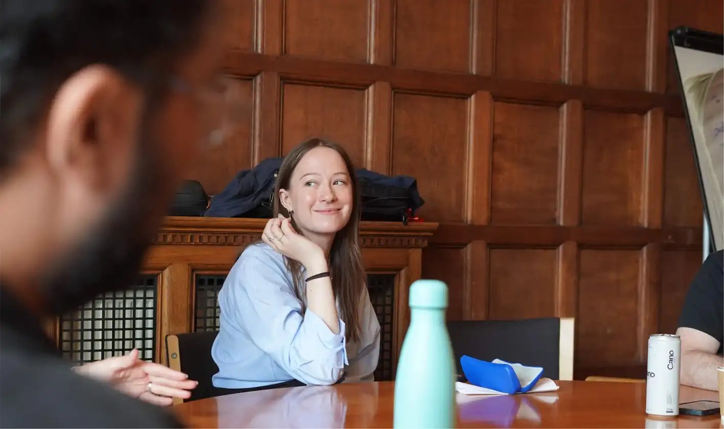 Articulate employee in discussion with colleagues (card size)