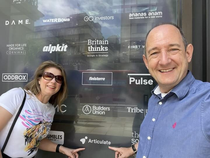 Image of our CEO and CFO outside B Corp certified, Coutts Bank, pointing to the Articulate logo