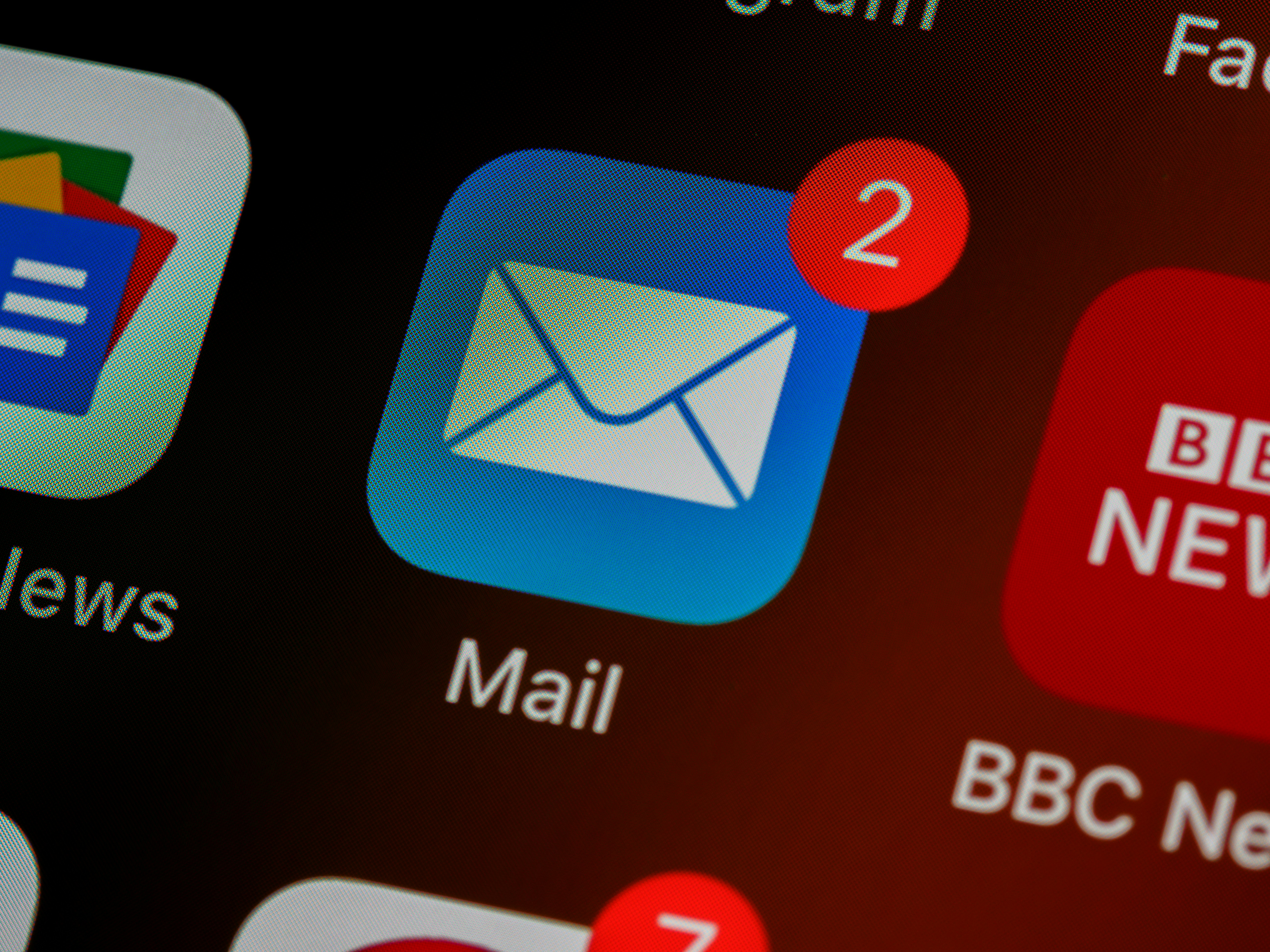 A blue email app icon on a screen with a red notification in the corner.